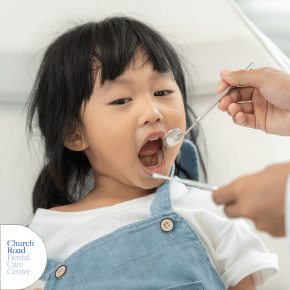 A young girl having her teeth checked at the dentist