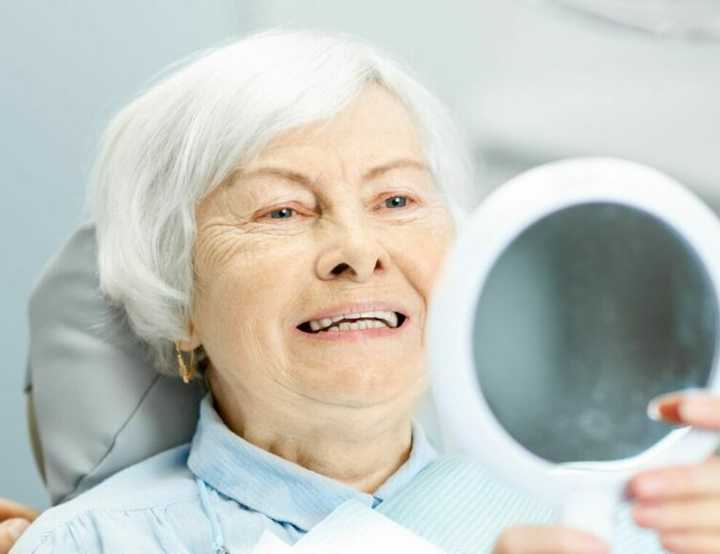 Client examining new dentures