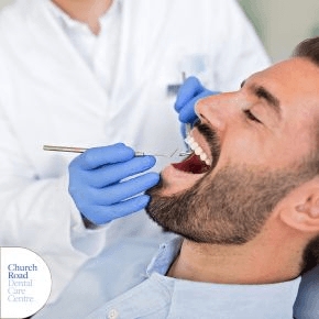 A man having his teeth checked by a dentist
